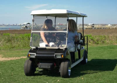 Long black and white golf cart