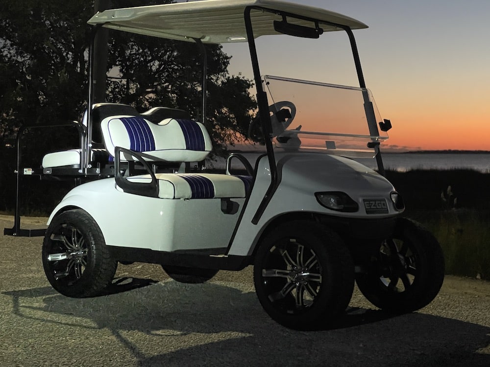 White golf cart at sunset