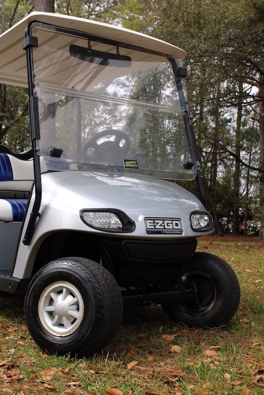 Silver 4-seater golf cart with white and blue seats