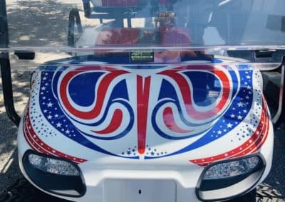 Custom starry red and blue vinyl decal on hood of white golf cart
