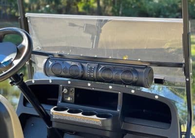 Exogear soundbar installed above dashboard of golf cart