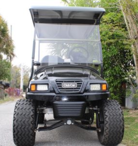 Club Car golf cart lifted to accommodate huge tires