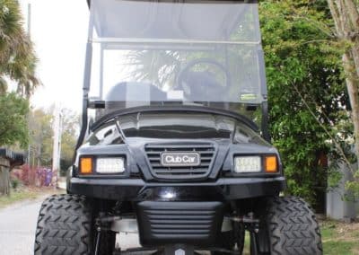 Club Car golf cart lifted to accommodate huge tires