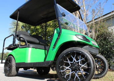 Custom lime green EZ Go golf cart with custom wheels