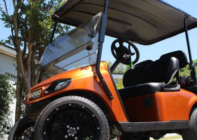 EZ Go Golf cart with custom orange paint job