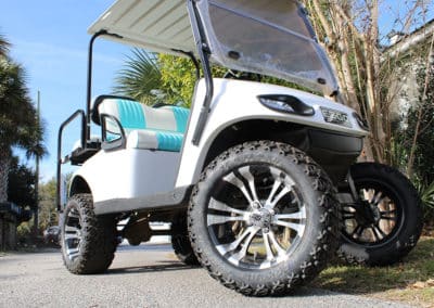 White golf cart with white and teal seats