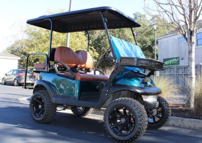 Golf cart with custom forest green paint job and faux leather seats