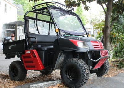 A Cushman Offroad custom red golf cart built sturdy and strong with extra storage